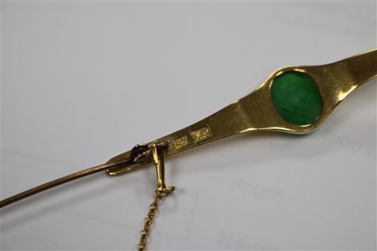 A Chinese yellow metal and jadeite cabochon bar brooch, 62mm.